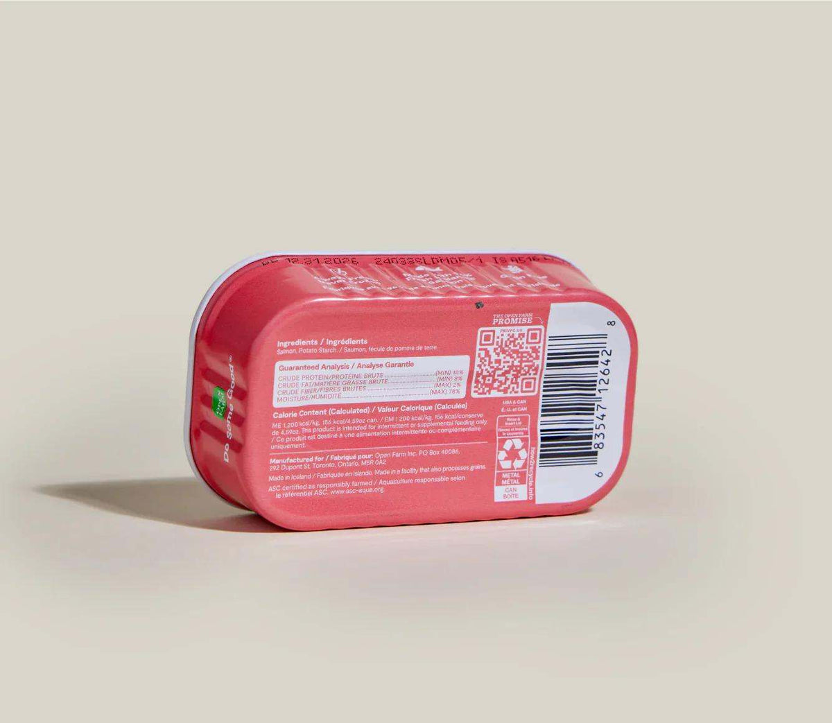 Salmon Topper for Dogs in a pink-red rectangular tub with a sealed lid and printed ingredient label, QR code, and barcode.