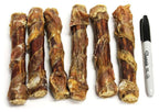 Tremenda Chewy Bulls natural beef dog chew treats wrapped in dehydrated beef bladder next to a black Sharpie marker for size comparison
