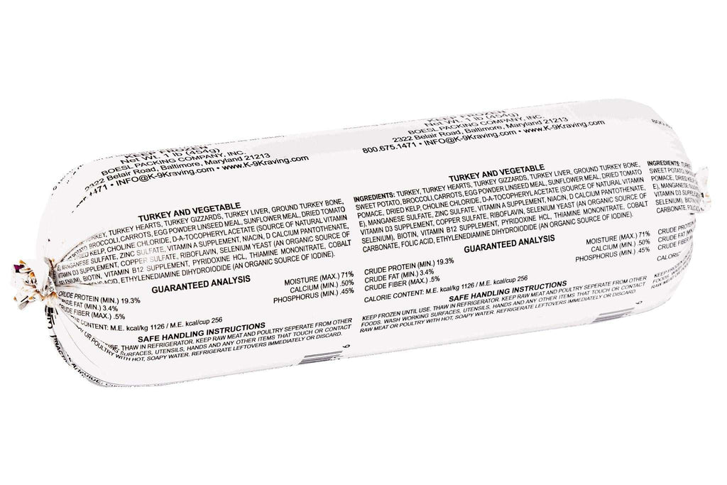 Raw dog food roll with white packaging and dense black printed ingredients and nutrition details, labeled Turkey and Vegetable.