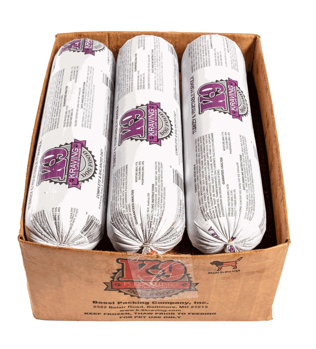 Turkey raw dog food in three white plastic-wrapped rolls with purple K-9 Kraving logos, packed in a brown cardboard box.