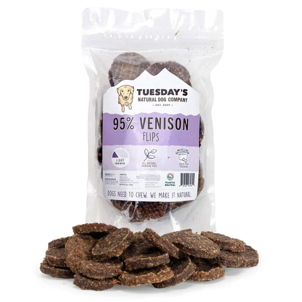 Venison Flips are brown, flat, irregularly round dog treats with a coarse, speckled texture.